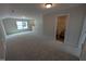 Carpeted bonus room with recessed lighting leads to an adjacent bathroom, providing convenience at 46 Steppe Way, Garner, NC 27529