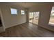 Bright dining area features hardwood floors, modern lighting, and sliding glass doors to the backyard at 46 Steppe Way, Garner, NC 27529