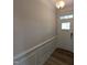 The entryway features beautiful wainscotting, wood flooring, and a front door with decorative glass at 46 Steppe Way, Garner, NC 27529