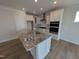 Kitchen island with granite countertop, stainless steel sink, and modern white cabinets at 46 Steppe Way, Garner, NC 27529