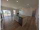 Kitchen island with granite countertop, stainless steel appliances, and open view of the living room at 46 Steppe Way, Garner, NC 27529