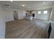 Open-concept living space with a kitchen island, wood flooring, and plenty of natural light at 46 Steppe Way, Garner, NC 27529