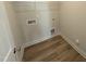 A functional laundry room is shown with a white wire shelf and connections for a washer and dryer at 46 Steppe Way, Garner, NC 27529