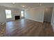 Spacious living room with wood flooring, a fireplace, and large windows for natural light at 46 Steppe Way, Garner, NC 27529
