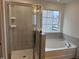 Bathroom with shower, tub, and modern vanity at 4937 S Trout Crest, Raleigh, NC 27604