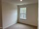 Bright bedroom with a window and carpet at 4937 S Trout Crest, Raleigh, NC 27604