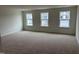 Spacious bedroom with three windows and carpet at 4937 S Trout Crest, Raleigh, NC 27604