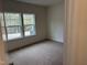 Bright bedroom with neutral carpet and two large windows at 4937 S Trout Crest, Raleigh, NC 27604