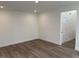 Spacious bonus room with hardwood floors and neutral walls at 4937 S Trout Crest, Raleigh, NC 27604