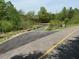 Paved community trail with scenic bridge and lush trees at 4937 S Trout Crest, Raleigh, NC 27604