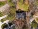 An aerial view of a luxury home, showcasing its well-maintained roof and mature trees surrounding the property at 501 Queensferry Rd, Cary, NC 27511