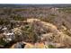 Aerial view showcasing homes on a golf course with mature trees at 501 Queensferry Rd, Cary, NC 27511