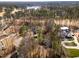 Aerial view of a neighborhood near a lake surrounded by a dense forest at 501 Queensferry Rd, Cary, NC 27511