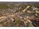 Aerial view of neighborhood homes adjacent to a golf course and pond at 501 Queensferry Rd, Cary, NC 27511