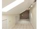 Attic storage space featuring tile floors, skylight, and access door at 501 Queensferry Rd, Cary, NC 27511