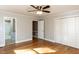 Bedroom with hardwood floors, ceiling fan, closet, and access to an adjoining bathroom at 501 Queensferry Rd, Cary, NC 27511