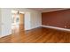 Bedroom featuring hardwood floors and neutral walls, with french doors leading to a sunroom and natural light at 501 Queensferry Rd, Cary, NC 27511