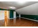 Bedroom featuring hardwood floors, sloped ceilings, and multiple doorways at 501 Queensferry Rd, Cary, NC 27511