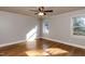 Sunny bedroom with hardwood floors and natural light from two windows at 501 Queensferry Rd, Cary, NC 27511