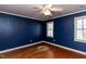 Bedroom features hardwood floors, a ceiling fan, and natural light from windows at 501 Queensferry Rd, Cary, NC 27511