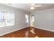 Bedroom with two windows, hardwood floors, neutral walls, and a ceiling fan at 501 Queensferry Rd, Cary, NC 27511