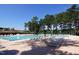 Community pool with plenty of lounge chairs and shady trees surrounding it at 501 Queensferry Rd, Cary, NC 27511