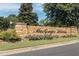Stone community entrance sign for MacGregor Downs with beautiful landscaping and a clear blue sky above at 501 Queensferry Rd, Cary, NC 27511