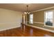 Inviting dining room featuring beautiful hardwood floors, wainscoting, and natural light from the windows at 501 Queensferry Rd, Cary, NC 27511