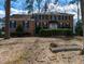 Traditional brick home with manicured hedges and mature trees on a spacious lot with lawn decorations at 501 Queensferry Rd, Cary, NC 27511