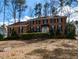 Traditional brick home with black shutters and manicured hedges on a spacious lot with lawn decorations at 501 Queensferry Rd, Cary, NC 27511