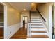 Welcoming foyer with hardwood floors, staircase, and views into the adjacent rooms of the home at 501 Queensferry Rd, Cary, NC 27511