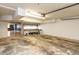 Spacious garage area with concrete flooring, storage shelving, and access to the kitchen at 501 Queensferry Rd, Cary, NC 27511