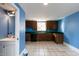 Kitchen area with wooden cabinets, a black dishwasher, and a view into the bathroom at 501 Queensferry Rd, Cary, NC 27511