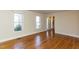 Spacious living room showcasing gleaming hardwood floors, neutral walls, and natural light from the windows at 501 Queensferry Rd, Cary, NC 27511