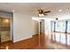 Bright, open living room features hardwood floors, a ceiling fan, and access to the bathroom and outdoor areas at 501 Queensferry Rd, Cary, NC 27511