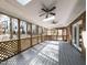 Large sunroom featuring skylights, ceiling fans, and lattice screens at 501 Queensferry Rd, Cary, NC 27511