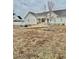 Landscaped backyard showcasing a charming home and a firepit area at 59 Mar-Joy Dr, Dunn, NC 28334