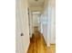 Light-filled hallway with hardwood floors and white doors at 59 Mar-Joy Dr, Dunn, NC 28334