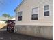 Side view of the house with a red deck and steps at 6020 Newhall Rd, Durham, NC 27713