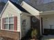 House exterior featuring vinyl siding, brick accents, and a red door at 6020 Newhall Rd, Durham, NC 27713