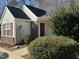 Charming one-story home with red door and well-manicured landscaping at 6020 Newhall Rd, Durham, NC 27713