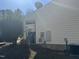 Side view of the house with vinyl siding and utilities at 6020 Newhall Rd, Durham, NC 27713