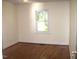 Bedroom with hardwood floors and a window at 648 Linfield Dr, Durham, NC 27701
