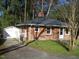 Brick house with a detached garage and driveway at 648 Linfield Dr, Durham, NC 27701