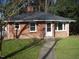 Brick ranch house with a spacious yard and a detached garage at 648 Linfield Dr, Durham, NC 27701