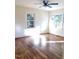 Bright living room with hardwood floors and large windows at 648 Linfield Dr, Durham, NC 27701
