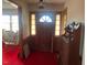 Inviting entryway with wood door and vintage furniture at 8110 Nc 210 N, Angier, NC 27501