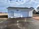 White detached garage with single door and overhead door at 8110 Nc 210 N, Angier, NC 27501