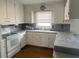 Classic kitchen with white cabinets and gray countertops at 8110 Nc 210 N, Angier, NC 27501