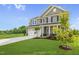 Two-story house with gray siding, white trim, and a two-car garage at 8805 Melvin St # 35, Willow Springs, NC 27592